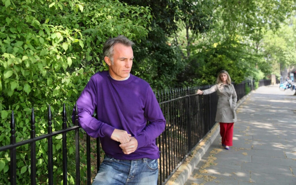 A woman and man apart with melancholic looks on their faces